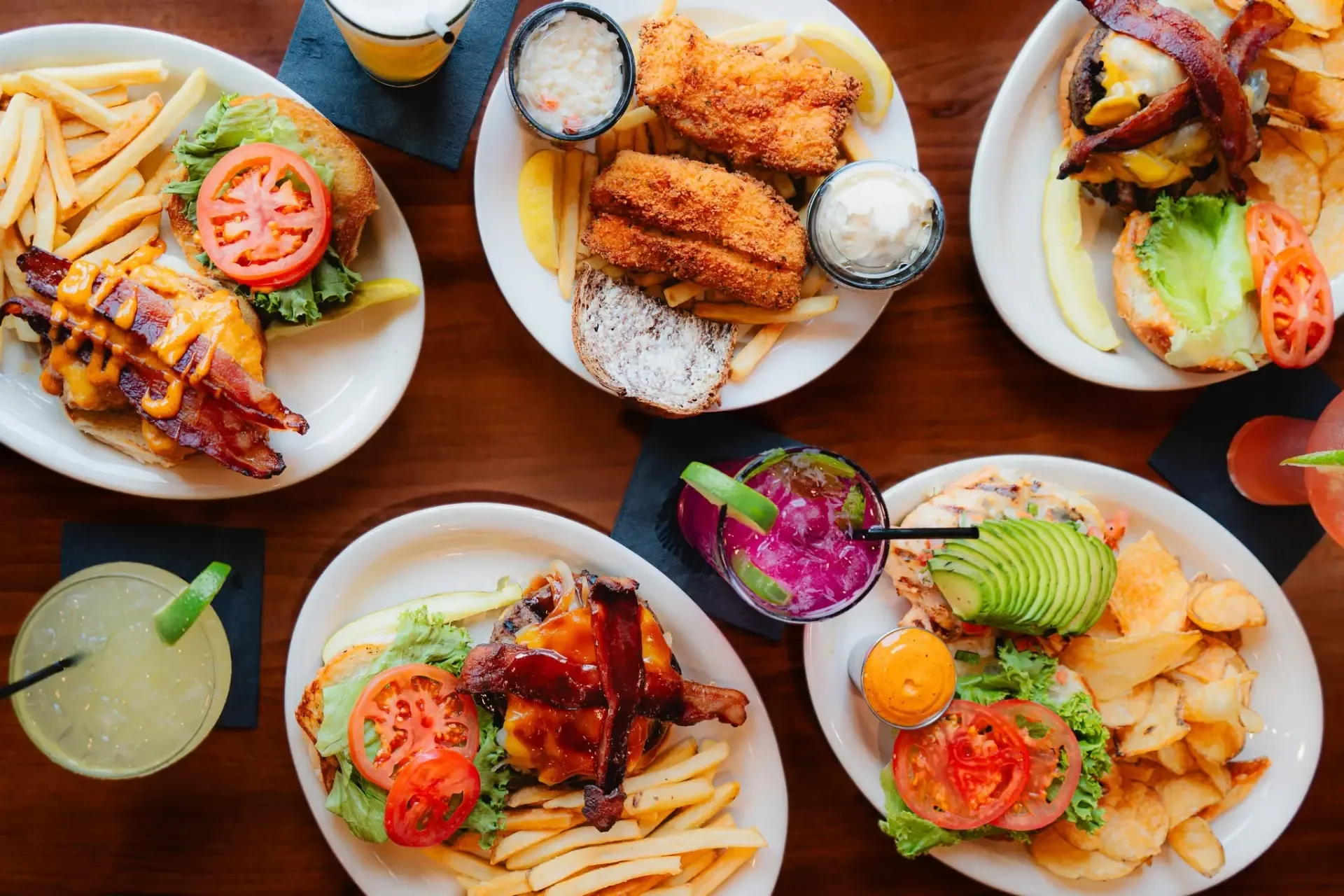 Plates of burgers, sandwiches, fish fry and cocktails from Jugs Pub and Grill